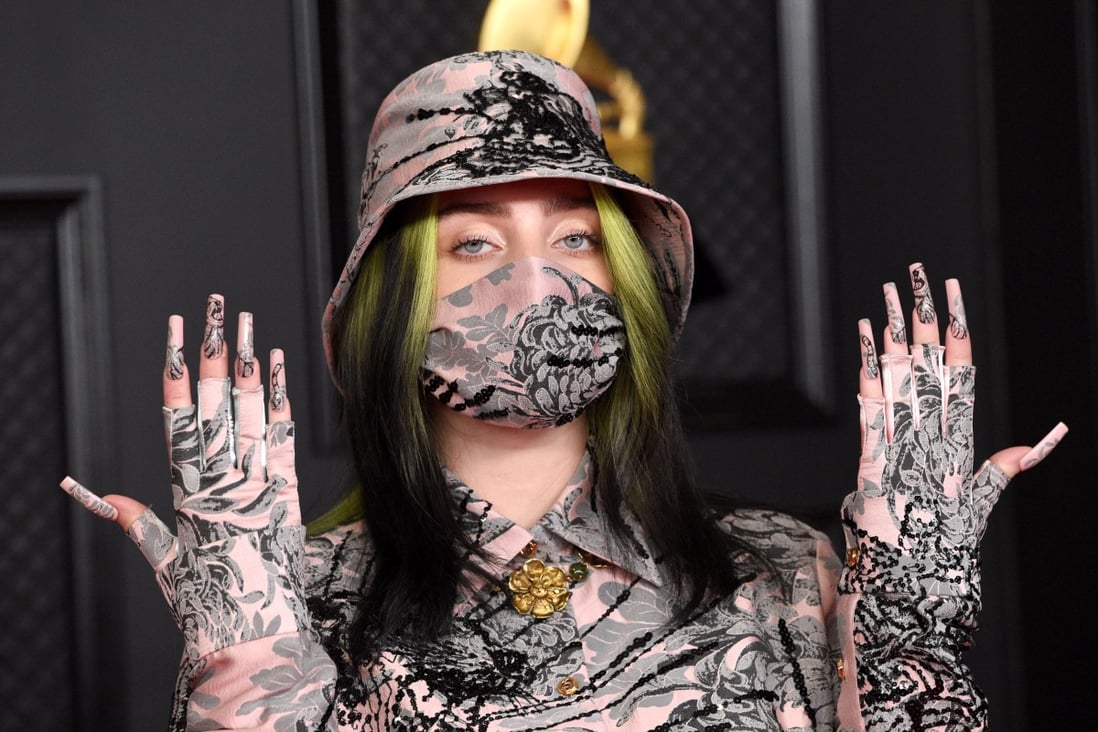 Billie Eilish covered up at the Grammy Awards and some have wondered if she was hiding her new blonde locks under a wig. Photo: EPA