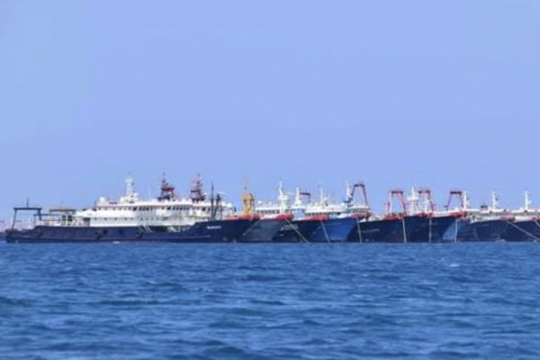 In this Sunday, March 7, 2021, photo provided Sunday, March 21, 2021, by the Philippine Coast Guard/National Task Force-West Philippine Sea, some of the 220 Chinese vessels are seen moored at Whitsun Reef, South China Sea. The Philippine government expressed concern after spotting more than 200 Chinese fishing vessels it believed were crewed by militias at a reef claimed by both countries in the South China Sea, but it did not immediately lodge a protest. (Philippine Coast Guard/National Task Force-West Philippine Sea via AP)