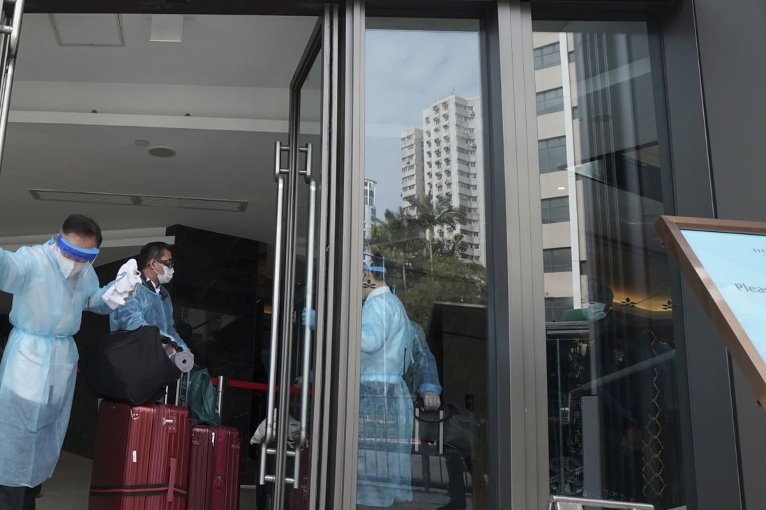 A traveller enters a designated Hong Kong hotel to undergo quarantine on December 18. The required period of isolation was increased from 14 to 21 days on December 25. Photo: Felix Wong