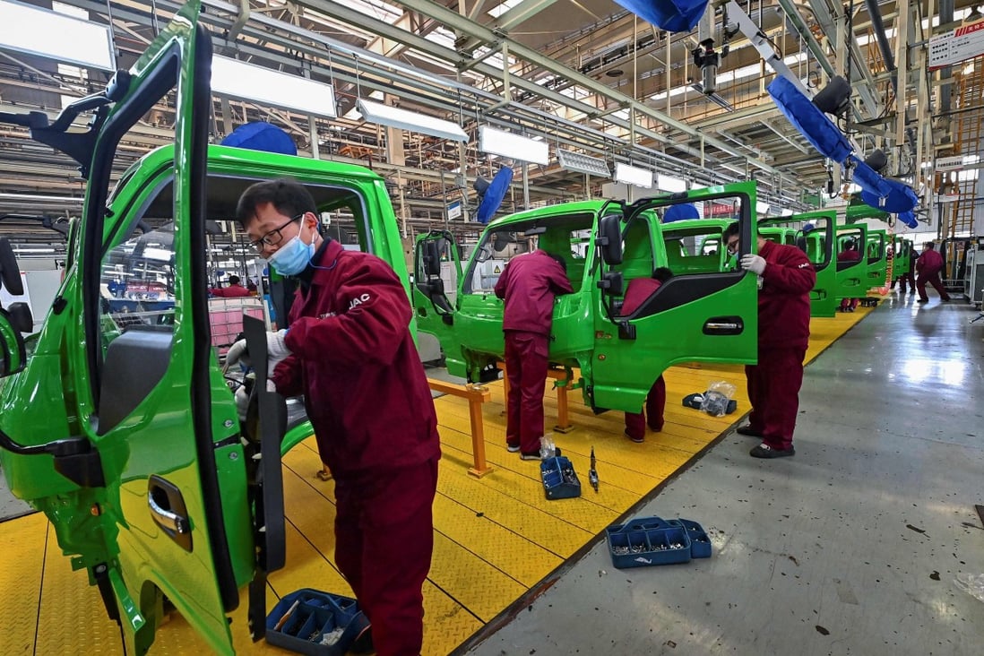 Employees work on a truck assembly line at a factory for Jianghuai Automobile Group in Qingzhou, Shandong province, in eastern China. Photo: AFP