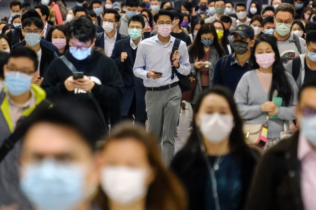 Residents wearing face masks walk through the MTR station in Central, Hong Kong. Photo: Bloomberg