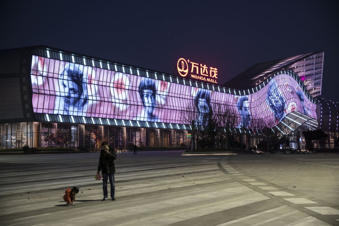 The Wanda Mall commercial complex covered with giant portraits of movie stars on its facade at the group’s film production hub in Qingdao, China. Photo: Bloomberg