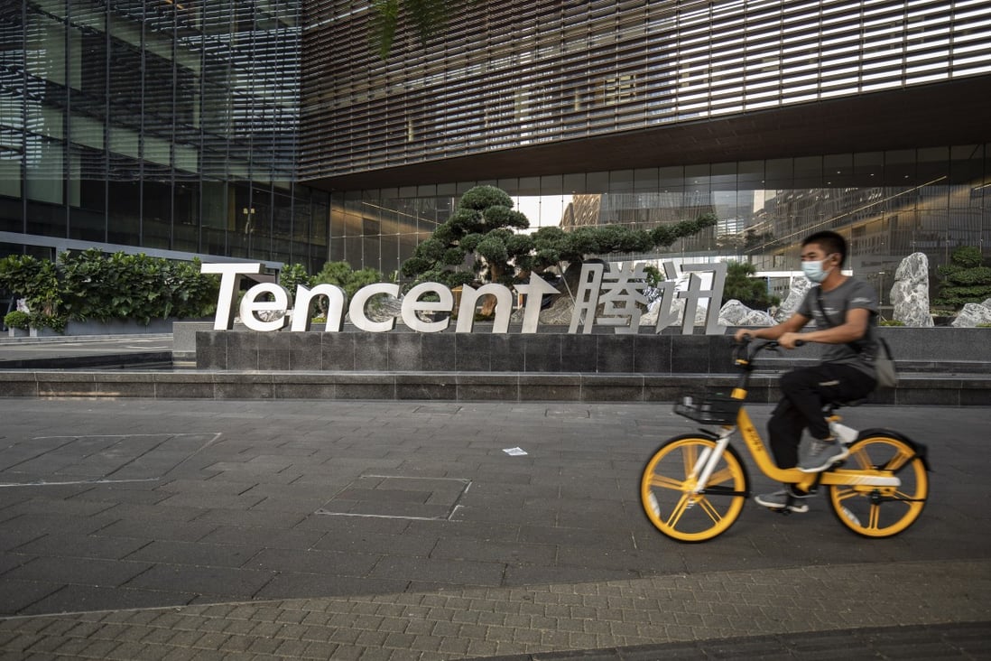 A cyclist wearing a protective mask rides past the Tencent Holdings logo at the company’s headquarters in Shenzhen on March 20. Photo: Bloomberg