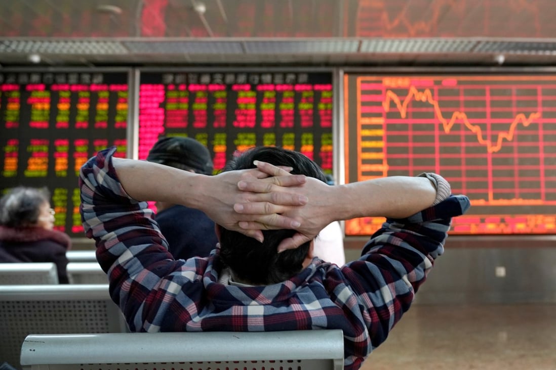 An investor looks at a stock quotation board at a brokerage office in Beijing, China January 3, 2020. Photo: Reuters