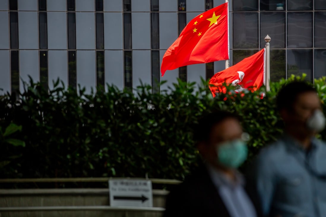 The Chinese and Hong Kong flags fly outside the government headquarters in Admiralty. Photo: Bloomberg