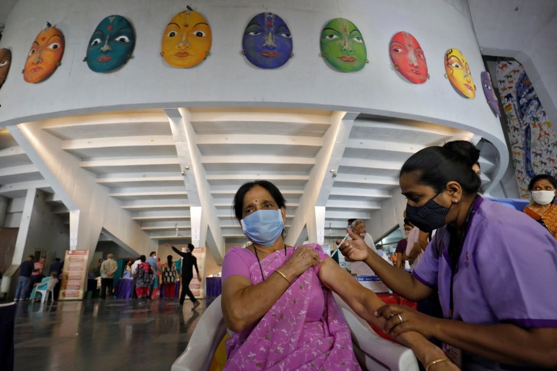 A woman receives a dose of Covishield, a Covid-19 vaccine manufactured by Serum Institute of India, at an auditorium which has been converted into a temporary vaccination centre, in Ahmedabad, India, on March 26. The Quad is looking to boost India’s vaccine diplomacy to counter China’s influence in the region. Photo: Reuters