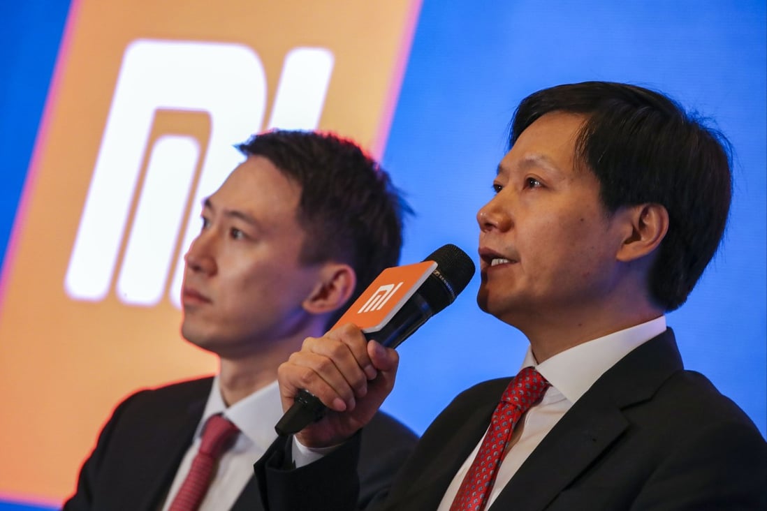 Chew Shou Zi, left, former Xiaomi Corp senior vice-president, is seen with company co-founder and chief executive Lei Jun during an event in Hong Kong on June 23, 2018. Photo: Edward Wong