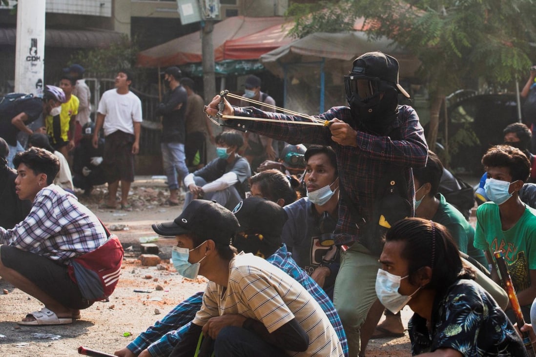 A man uses a slingshot during a protest against the military coup in Yangon, Myanmar. Photo: Reuters