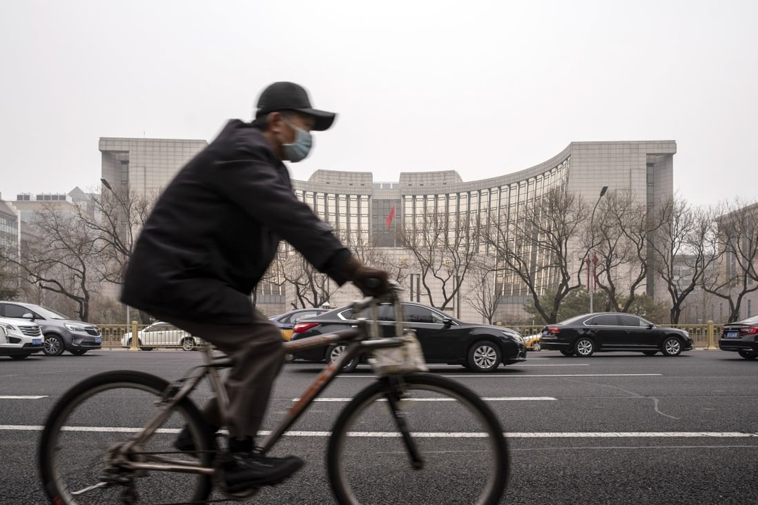 A cyclist rides past the People's Bank of China building in Beijing. FTSE Russell said on Tuesday it would begin including Chinese government debt in its flagship bond index in October. Photo: Bloomberg
