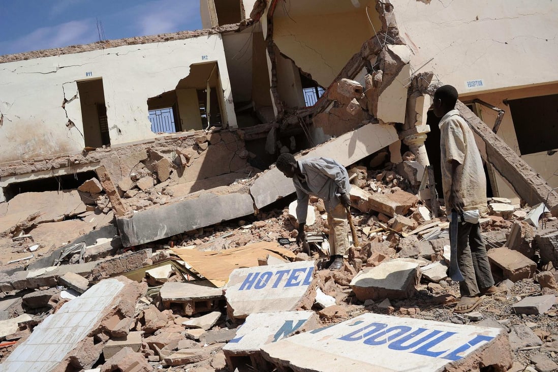 Children search in the ruins of a hotel destroyed by French air strikes in  Douentza in February 2013. A new UN report says a French air strike  killed 19 civilians in Mali in January. Photo: AFP