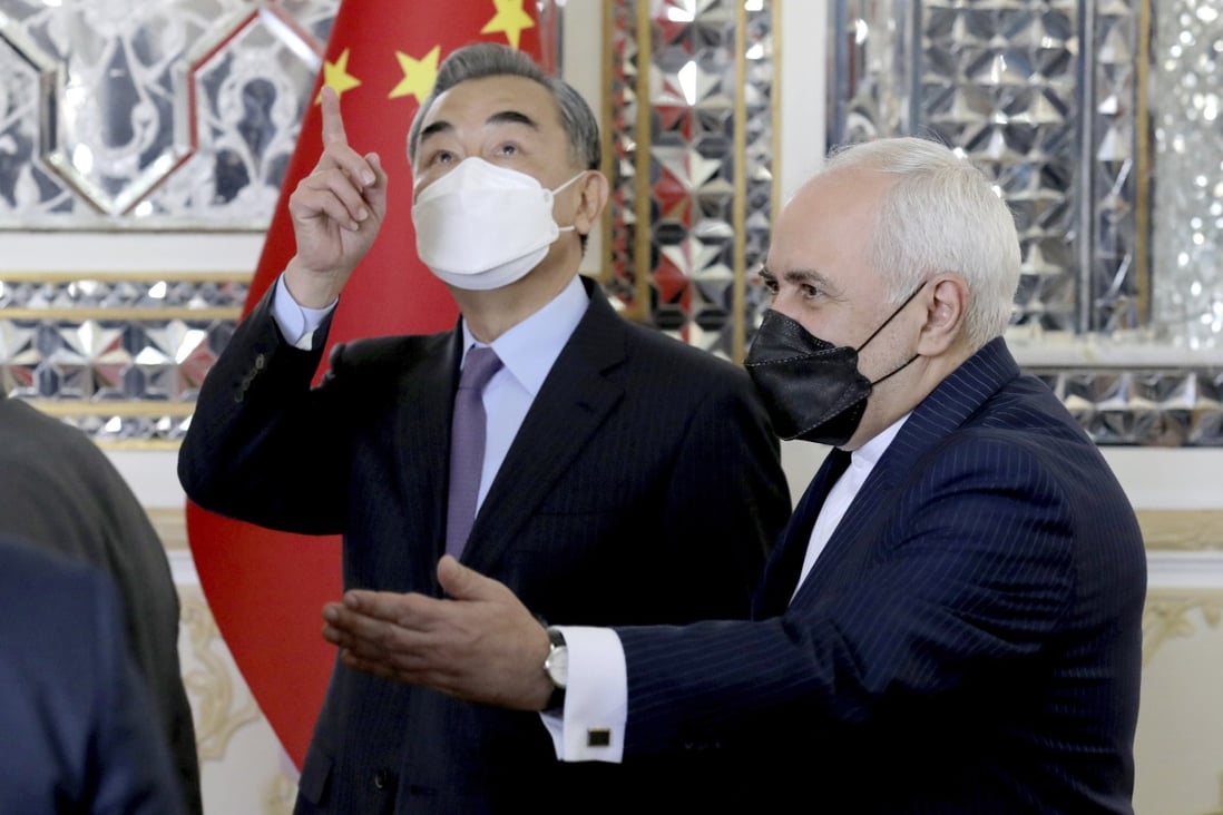 Iranian Foreign Minister Mohammad Javad Zarif welcomes Chinese Foreign Minister Wang Yi in Tehran on Saturday. Photo: AP