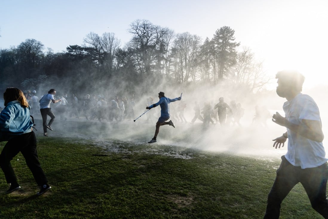 Party-goers in Brussels, Belgium, run from water cannon fired by police to disperse a large crowd gathering for a festival in the Bois de la Cambre park. Photo: ZUMA Wire / DPA