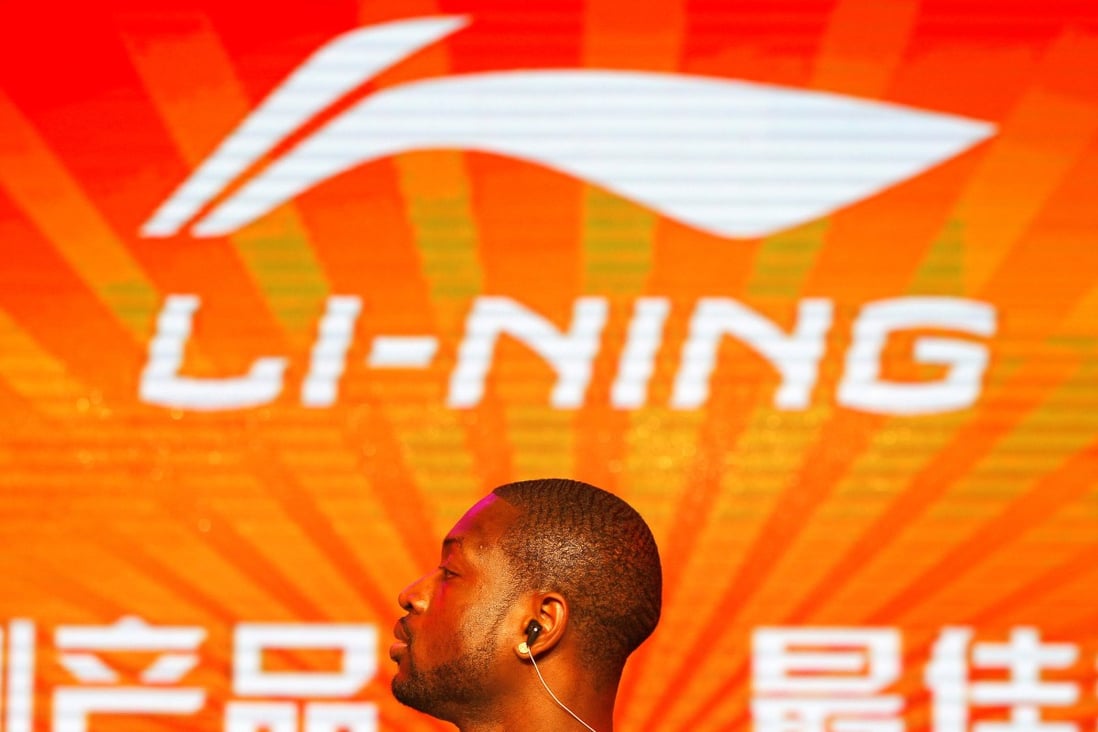 Former NBA Miami Heats Dwyane Wade stands in front of a company logo of Li Ning during a promotional event for Li Nings Way of Wade sneakers in Beijing in July 2013. Wade signed a multi-million dollar contract with Li Ning in 2012.but the sneakers that bear his name are in short supply. Photo: Reuters