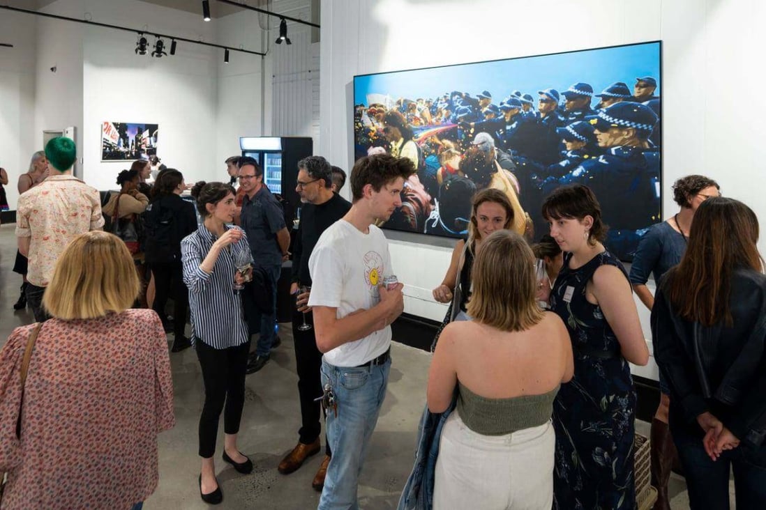 Visitors at an aMBUSH Gallery exhibition in Canberra on March 11, 2021. Photo: Facebook/aMBUSH Gallery