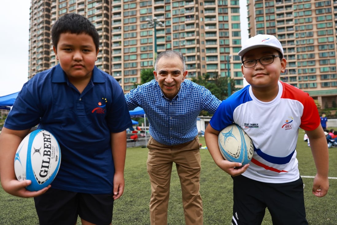 Integrated Brilliant Education Limited students Aris Gurung, school CEO and cofounder Manoj Dhar and student Abhi Limbu at a Hong Kong Rugby Union rugby fun day at King’s Park, Jordan in April. Photo: SCMP / May Tse  