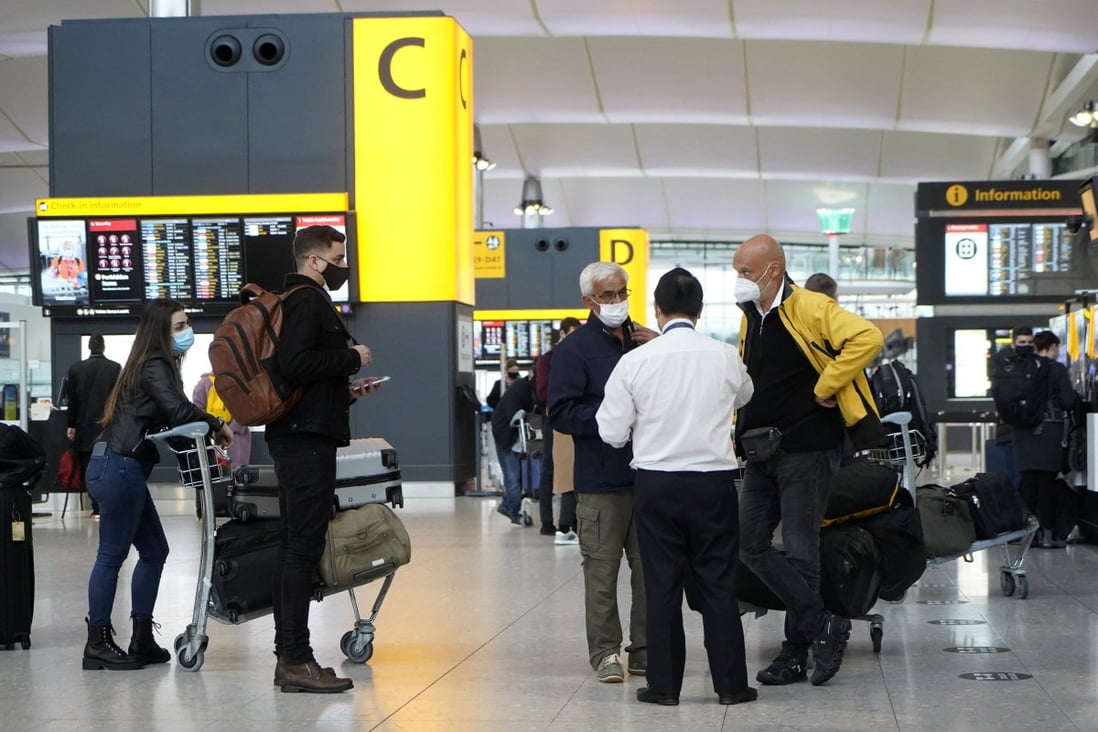 Travellers wait near the check-in desks at Terminal 2 of Heathrow Airport. Photo: AFP