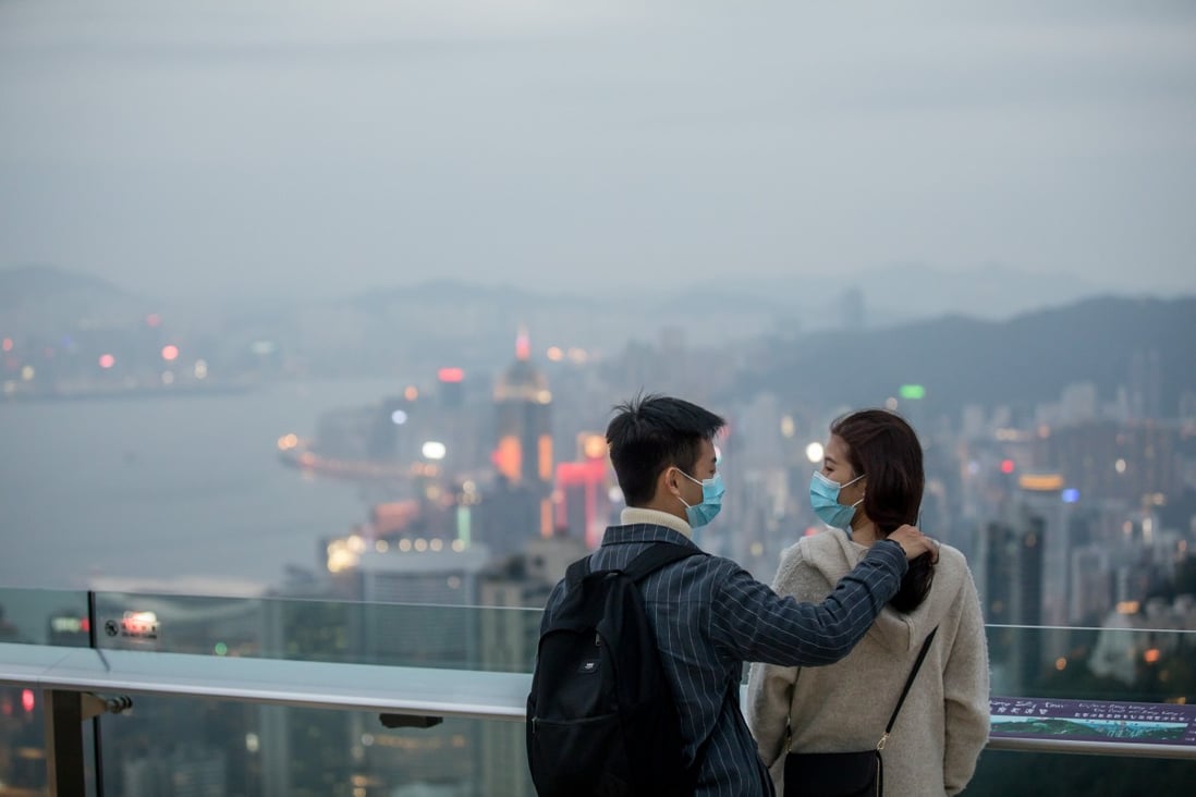 A couple visit Victoria Peak in Hong Kong in February last year. The government’s scheme is meant to give the battered hotel industry in Hong Kong a boost. Photo: Bloomberg 