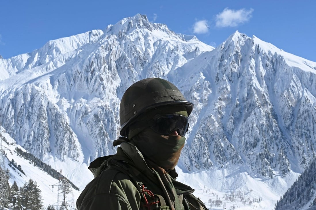 An Indian army soldier stands on a snow covered road in the Himalayas. Photo: AFP
