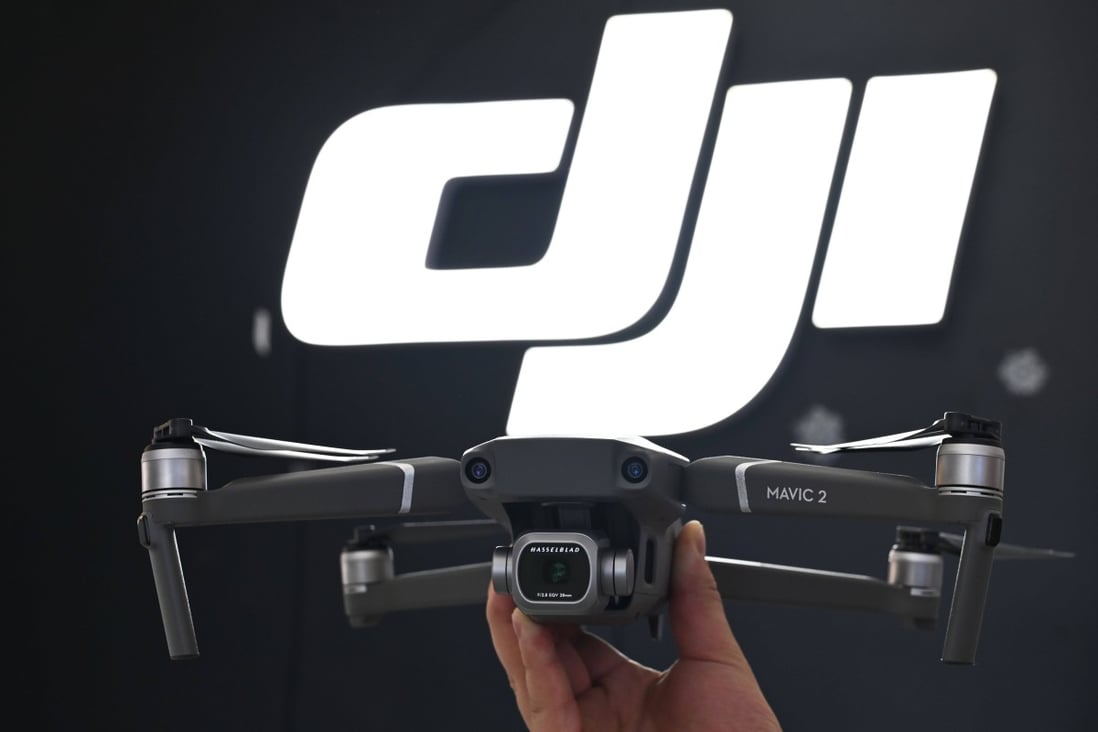 An employee shows the new Mavic Pro 2 drone in a DJI store in Shanghai on May 22, 2019. Photo: AFP