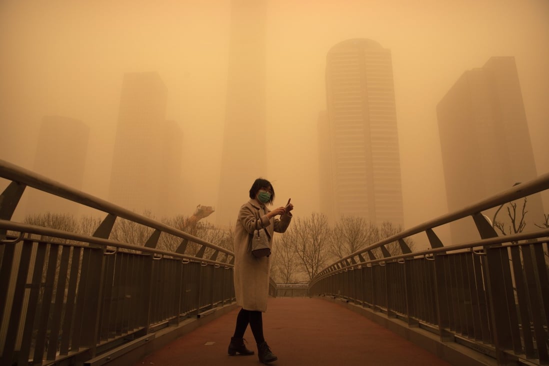 A woman walks along a bridge during the morning rush hour in the central business district in Beijing on March 15. Photo: AP