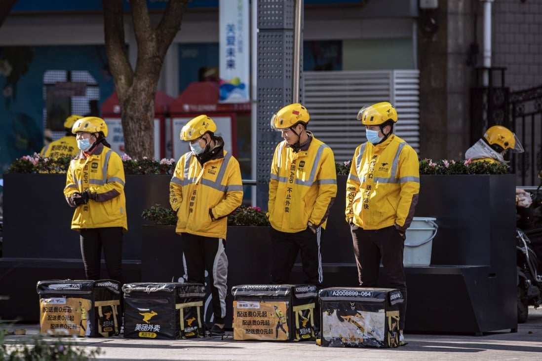Food delivery couriers for Meituan stand with insulated bags during a morning briefing in Shanghai, China. Photo: Bloomberg