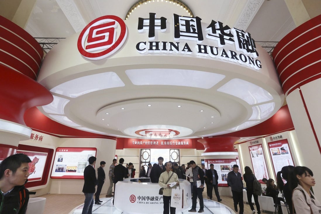 China Huarong Asset Management Company both at a finance expo in Beijing in 2014. The company's dollar-denominated bonds have declined sharply in recent weeks after it missed a deadline to report its annual results in March. Photo: Reuters