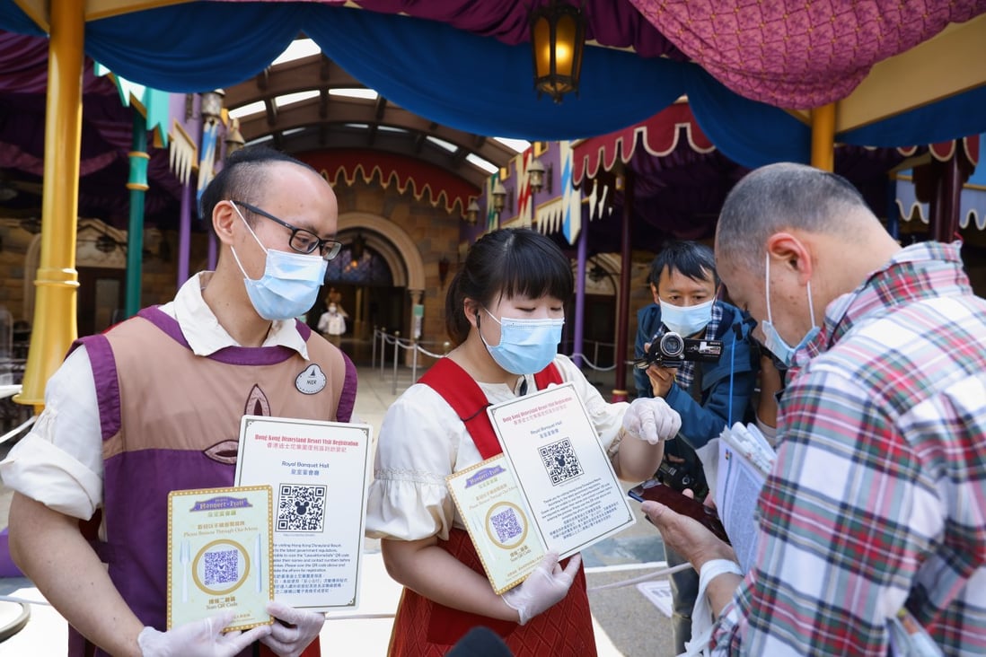 People using the “Leave Home Safe” app scan QR codes to dine in a restaurant at Hong Kong Disneyland. Photo: Dickson Lee