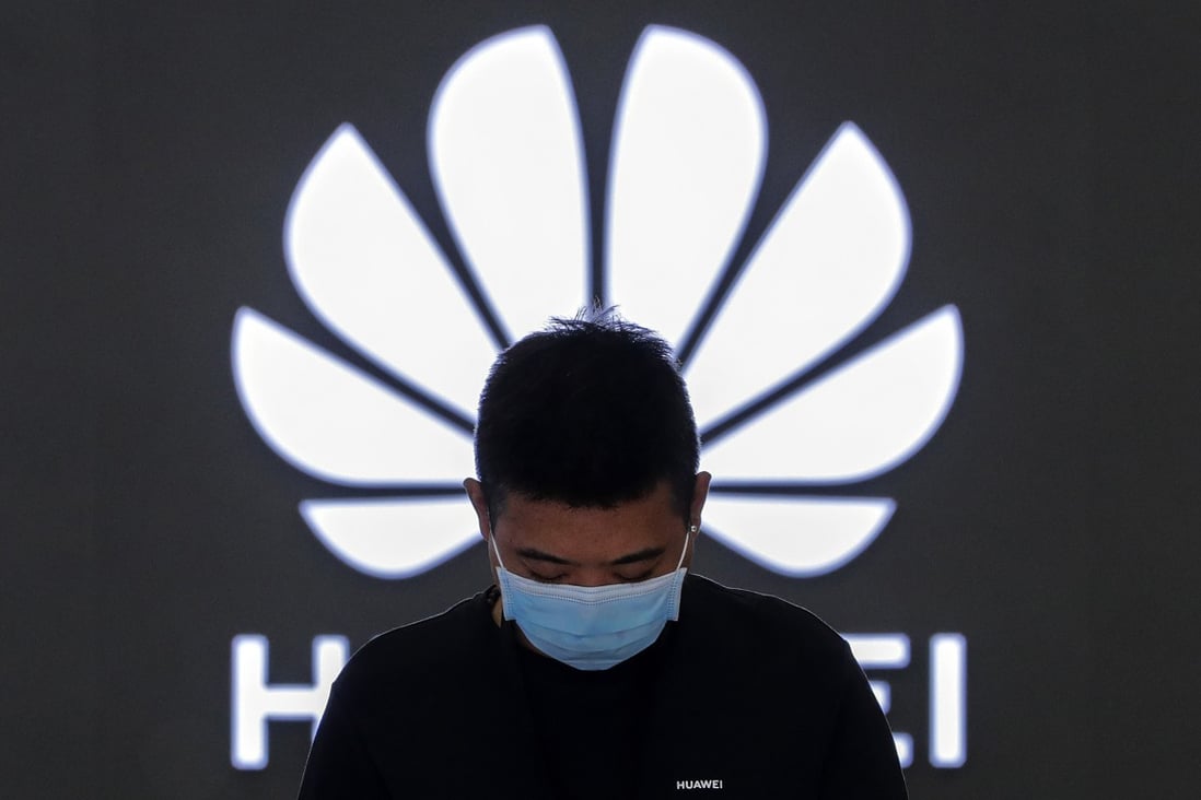 An employee stands inside a Huawei flagship store in Beijing, China, on August 31, 2020. Photo: AP Photo