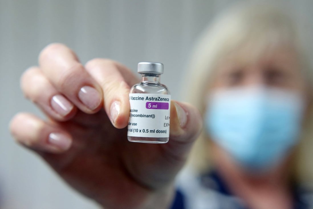 A health care worker displays a vial of the AstraZeneca/Oxford Covid-19 vaccine at a medical practice in Britain. Photo: AFP