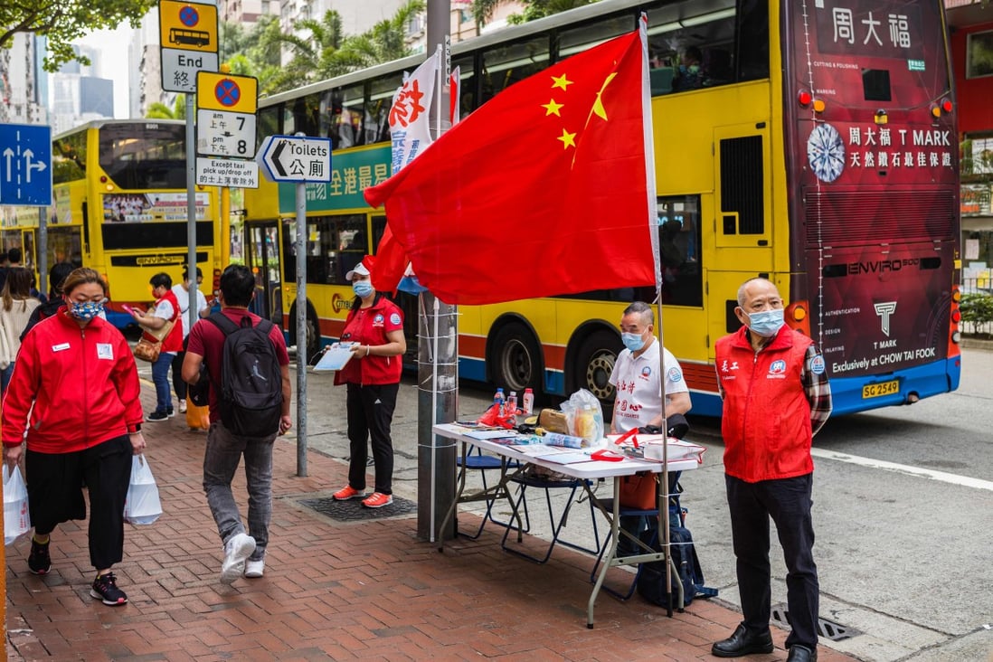 China’s flag is displayed at a stall where residents can sign in favour of changes to the local electoral system in Hong Kong on March 11. Photo: AFP