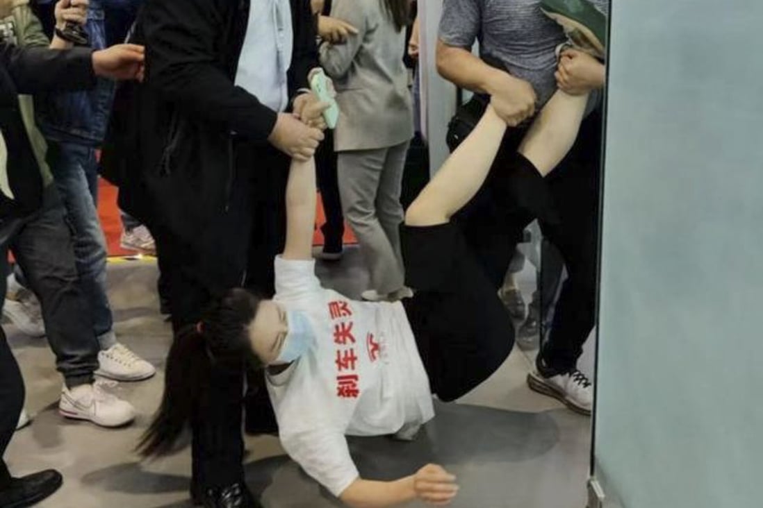 A woman surnamed Zhang climbed onto a Tesla at a Shanghai Auto Show to protest after her Tesla brakes allegedly failed. Photo: Baidu