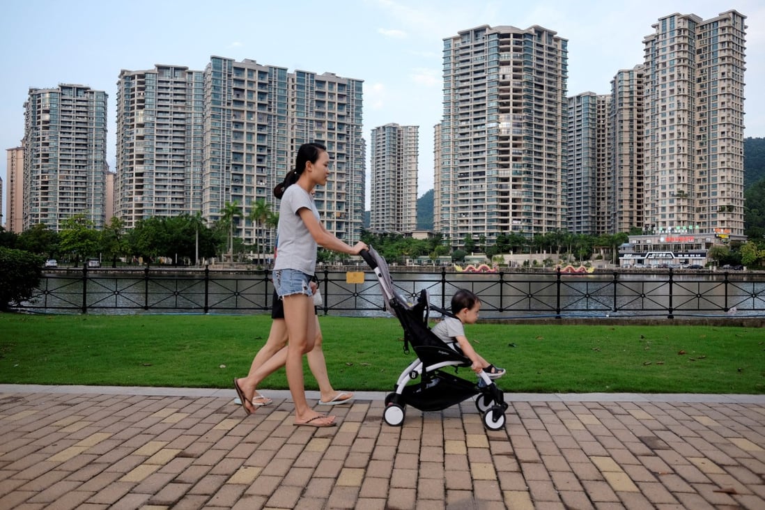 People walk past a residential property development by Agile Property in Zhongshan, Guangdong. Photo: Reuters
