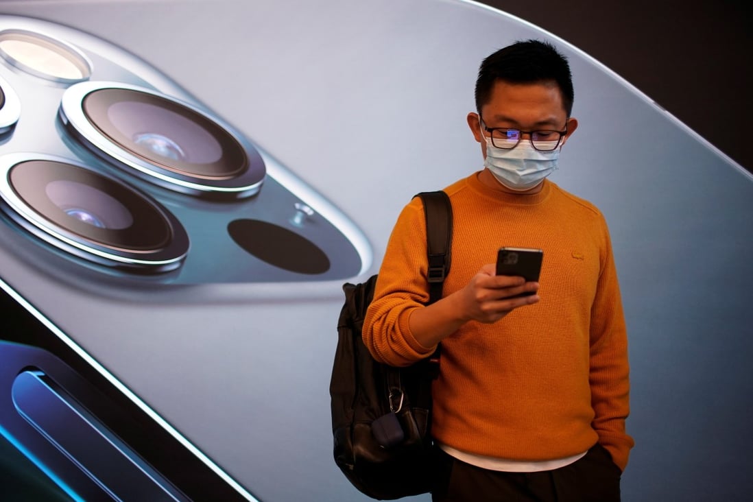 A man stands at an Apple Store before the brand’s new 5G iPhone 12 goes on sale in Shanghai, China, on October 23, 2020. Photo: Reuters
