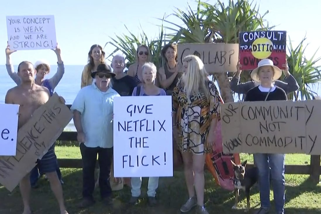 Protesters display placards at Byron Bay, Australia, this week in opposition to the filming of a reality television series that some fear will damage the reputation of the tourist town. Photo: Australian Broadcasting Corporation via AP