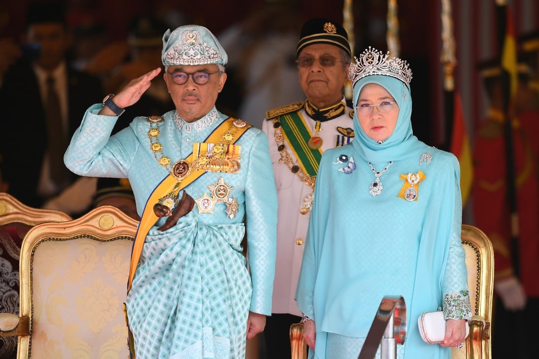 Malaysia’s King Sultan Abdullah and Queen Tunku Azizah Aminah pictured at Parliament House in Kuala Lumpur in 2019, as then-Prime Minister Mahathir Mohamad looks on. Photo: AFP