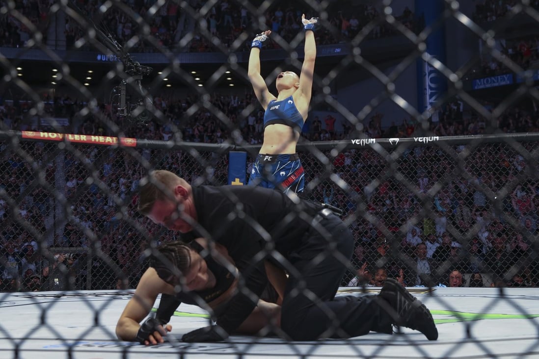 Rose Namajunas celebrates as the referee kneels over Zhang Weili at UFC 261. Photo: AP