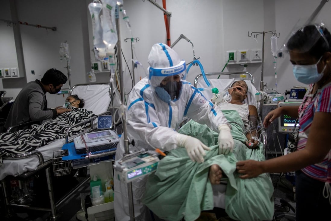 A health worker tends to a Covid-19 patient supported by a mechanical ventilator and undergoing dialysis at a government hospital in Quezon City, the Philippines. Photo: Reuters