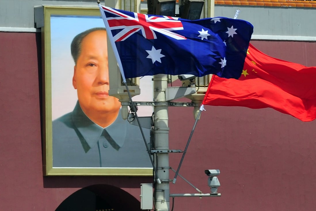 The Australian and Chinese flags in front of a portrait of Mao Zedong in Tiananmen Square, Beijing. Photo: AFP