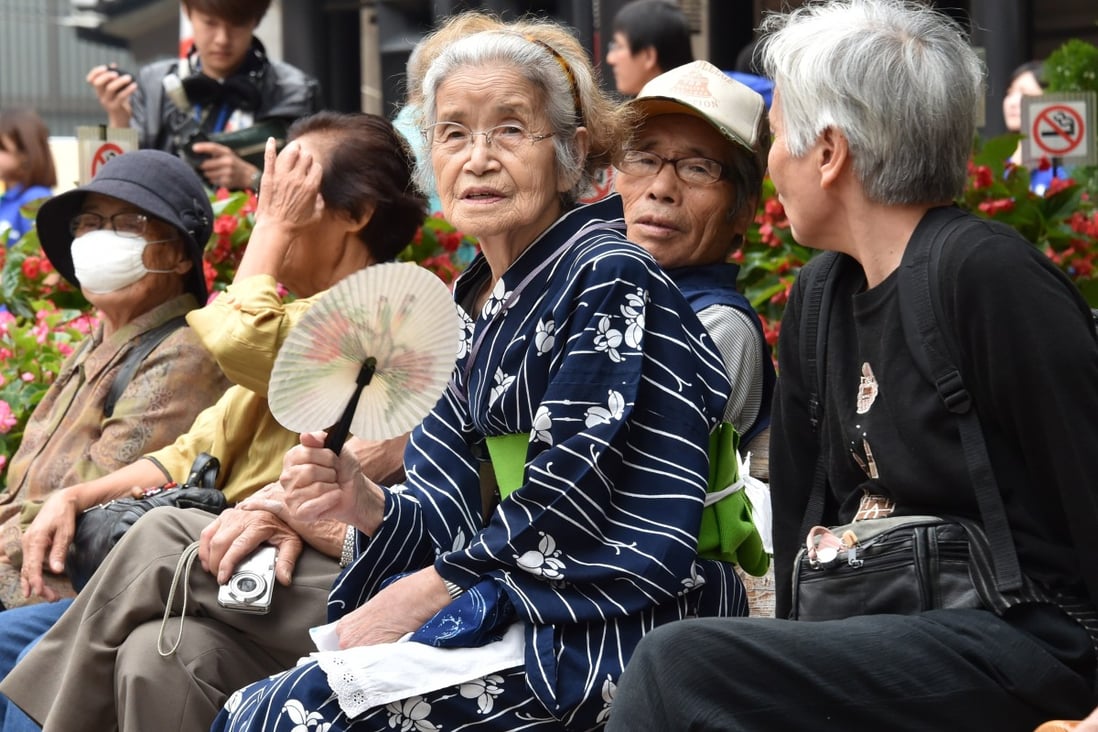 Elderly residents rest at the grounds of a temple in Tokyo. Photo: AFP