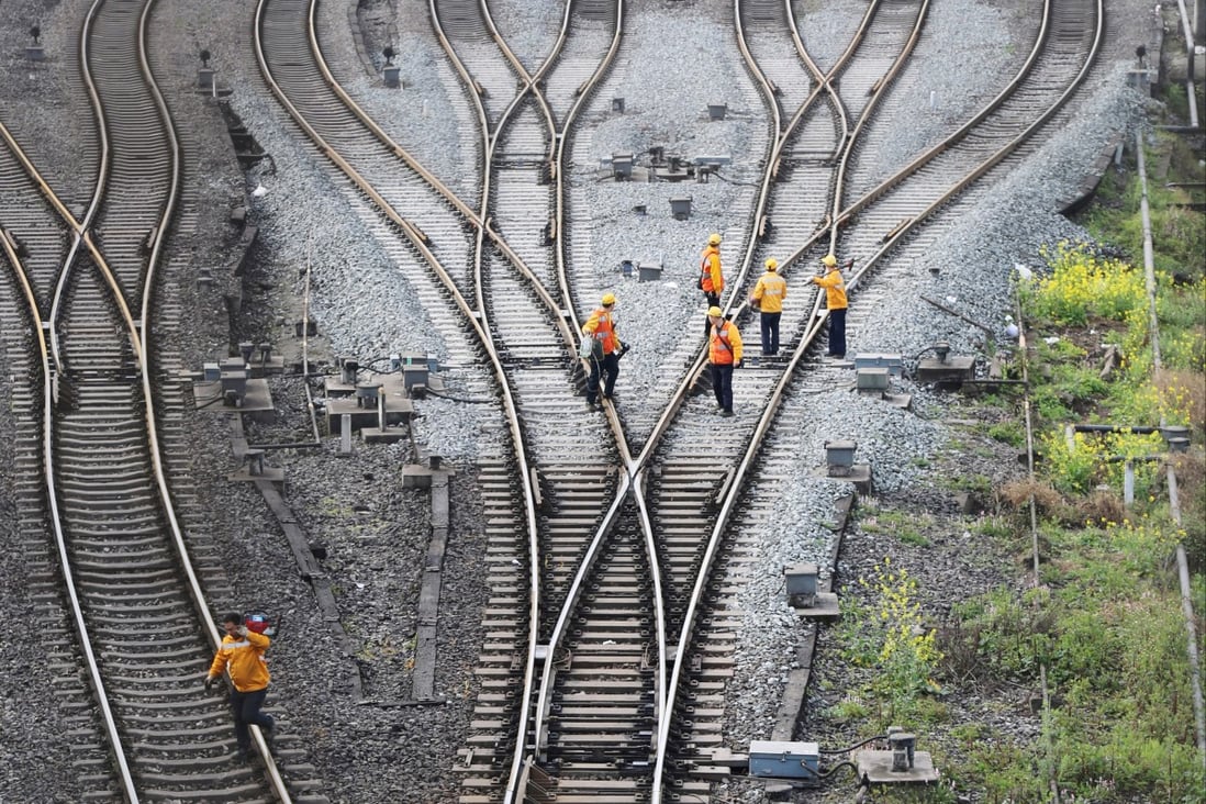 Workers inspect the tracks of a rail route that links China’s Chongqing to Duisburg in Germany under the Belt and Road Initiative. Photo: Reuters