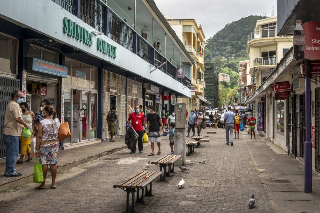 Pedestrians walk on a street in the capital Victoria, Seychelles. File photo: AP