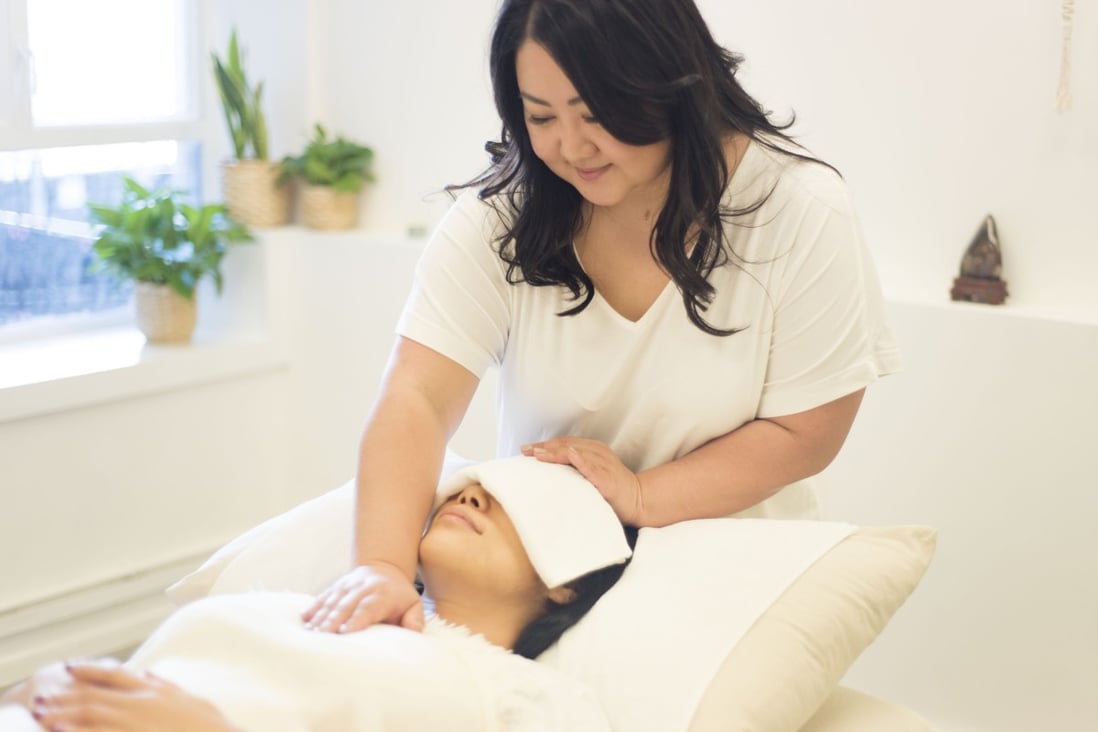 Reiki, performed here by Hong Kong healer Corie Chu, is an alternative therapy in which energy is channelled to treat physical and emotional woes. It is gaining followers as an effective complement to Western medicine. Photo: Camilla W Photography