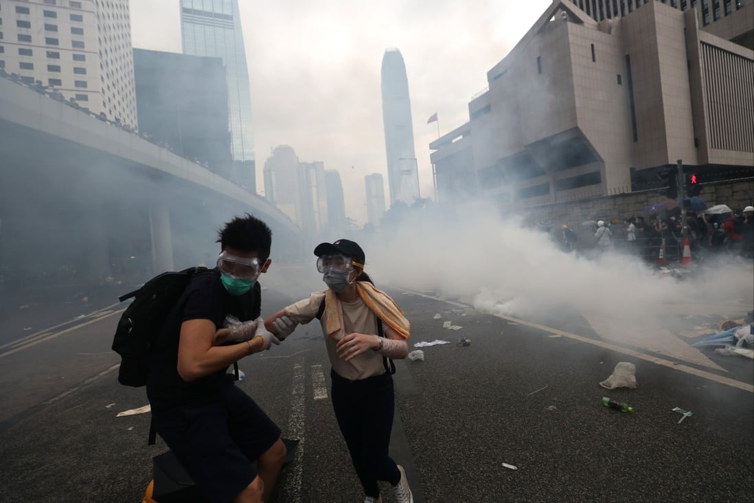 Anti-extradition bill protesters run from a cloud of tear gas on Harcourt Road in Admiralty, on June 12, 2019. Photo: Sam Tsang