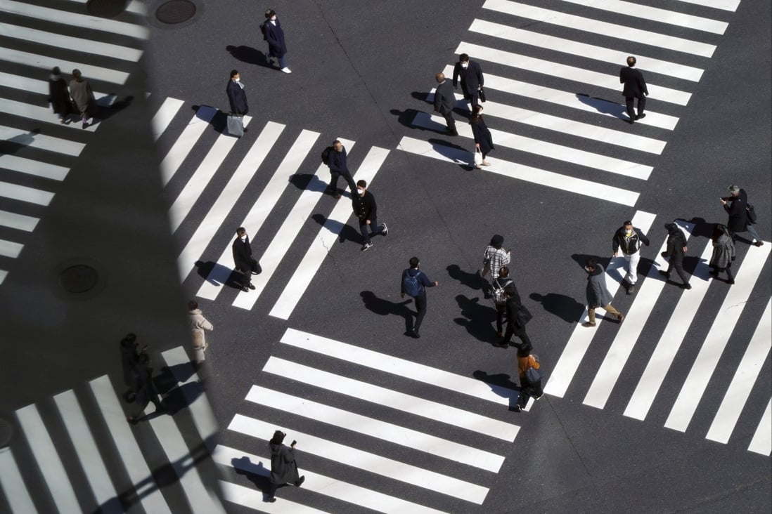 People use a pedestrian crossing in Tokyo on March 3. After a slow start, Japan’s vaccination campaign has started to take off. Photo: AP 