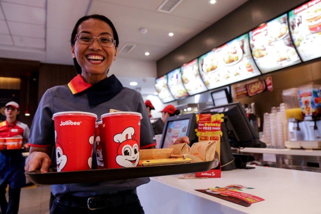 A Jollibee worker serves a meal at an outlet in Pasig City. Photo: SCMP/Jansen Romero
