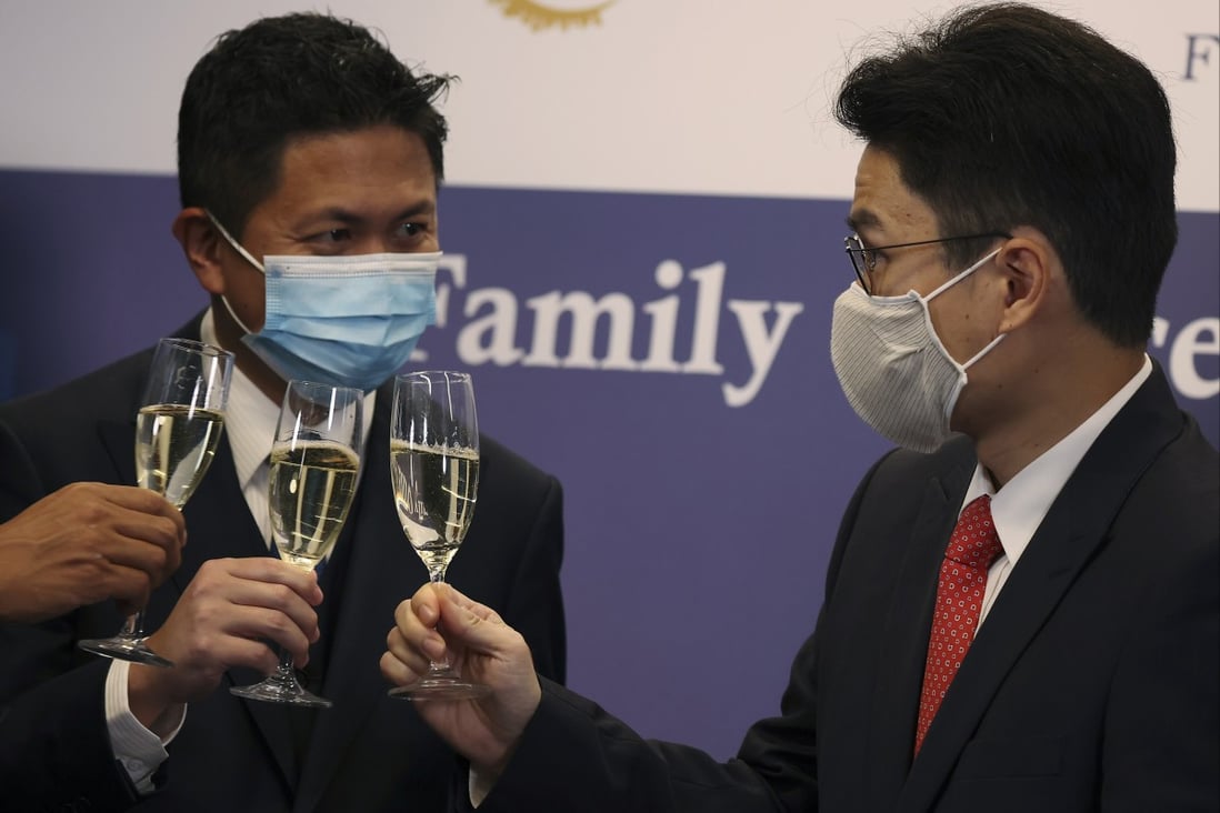 Kwan Chi-man (left), chairman of the Family Office Association of Hong Kong, and Undersecretary for Financial Services and the Treasury Joseph Chan Ho-lim toast at the opening ceremony of the Family Office Association of Hong Kong at the InvestHK office in Admiralty on November 18, 2020. Photo: Nora Tam