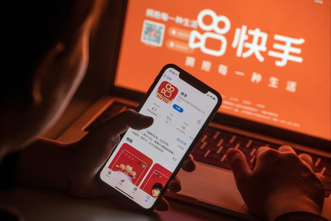 The Kuaishou app download page on a smartphone is seen in front of the company’s website. Photo: Bloomberg
