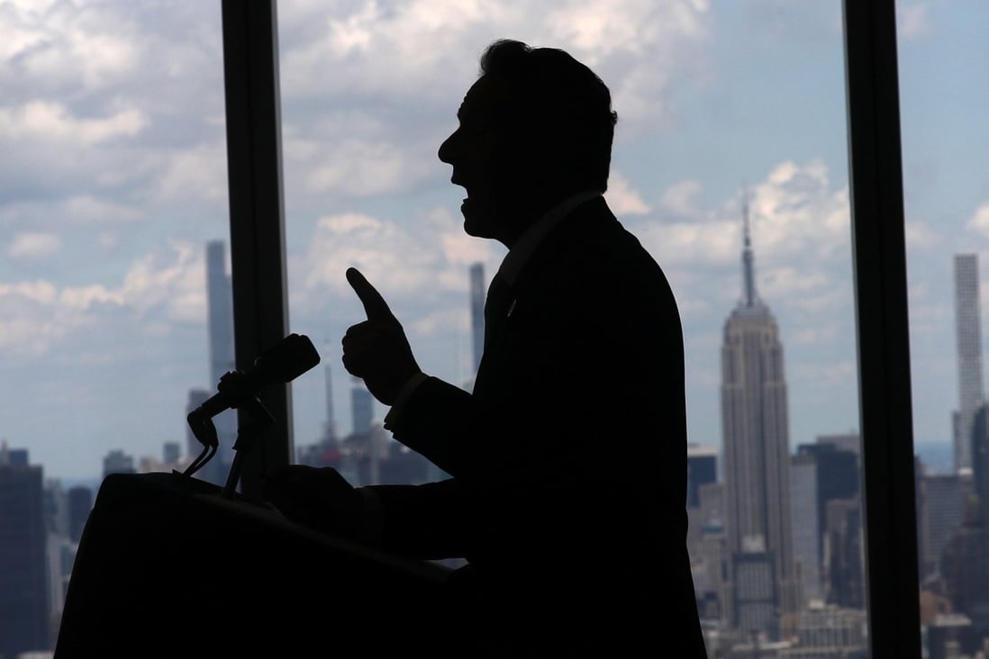 New York Governor Andrew Cuomo speaks with the skyline of Manhattan behind him on Tuesday as he announces the lifting of pandemic restrictions. Photo: Reuters