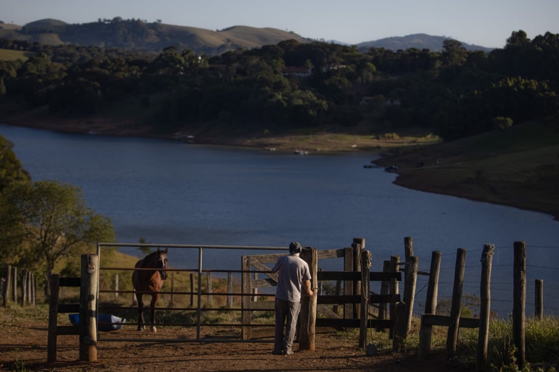 A farm worker at the Jacarei Reservoir, near Joanopolis, Brazil, on June 13. In Brazil, forecasts for consumer prices are being revised upwards, not downwards. Part of the problem is that a once-in-a-century drought has pushed up electricity prices - something that is beyond the control of central banks. Photo: Bloomberg