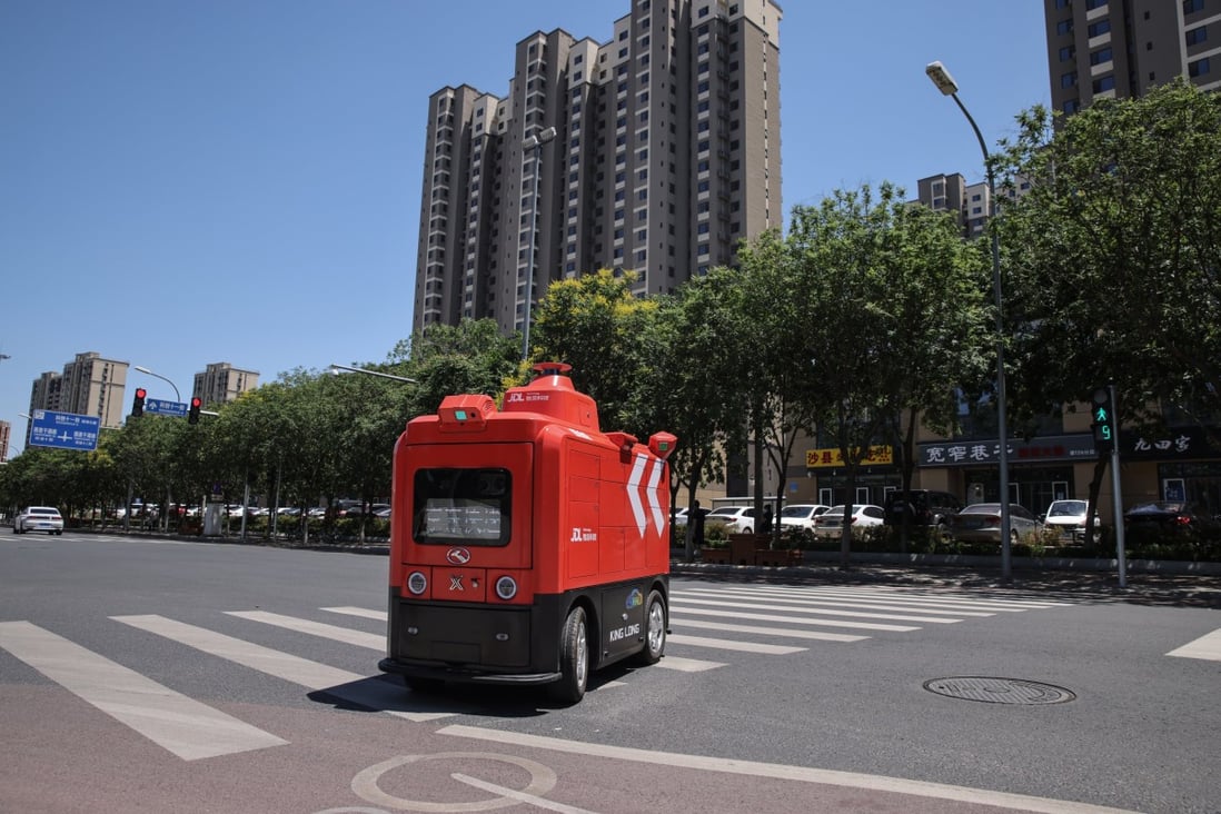 A JD.com unmanned distribution vehicle delivers goods in Beijing, China, in June. Photo: EPA-EFE